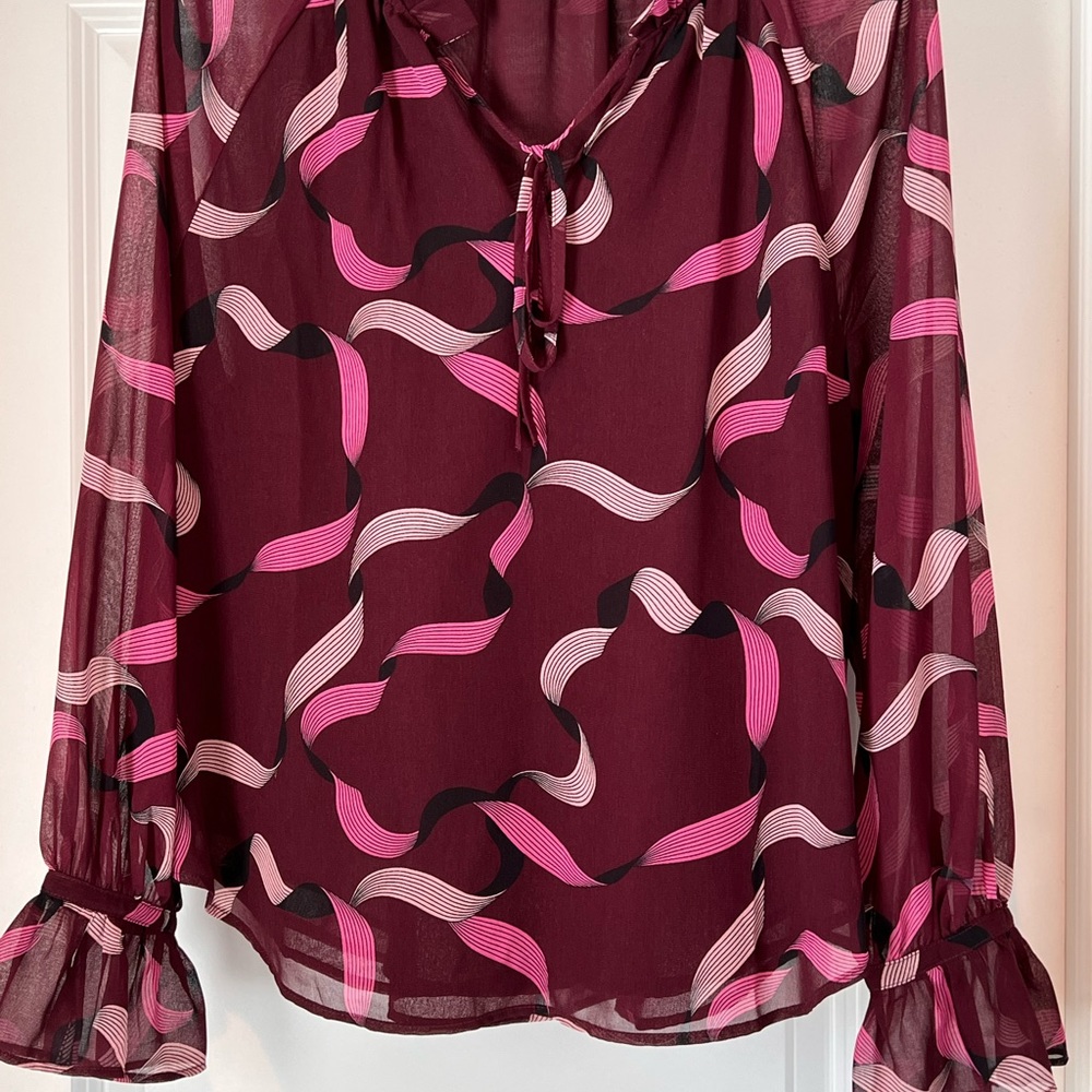 Ann Taylor Blouse. Sheer burgundy and pink with ruffle sleeve and tie neck.